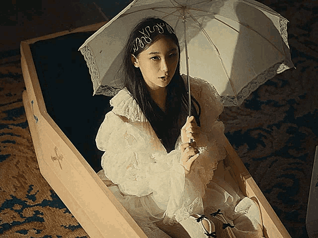 a woman in a white dress is holding an umbrella