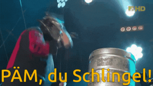 a man standing next to a barrel with the words pam du schlingel