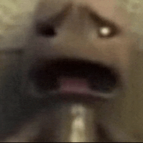 a close up of a person 's face with their mouth open and a light coming out of it .