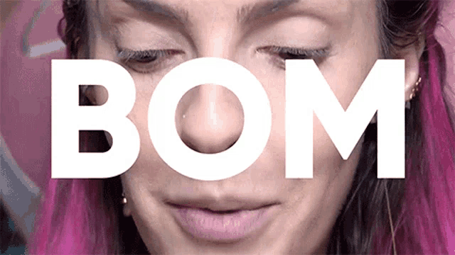 a close up of a woman 's face with the word bom in white letters