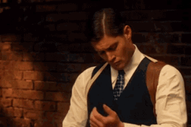 a man in a suit and tie is looking down