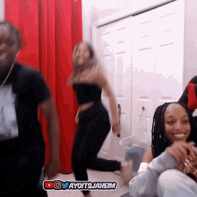 a group of people are dancing in front of a red curtain and a youtube logo