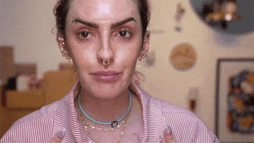 a close up of a woman 's face with a nose ring .