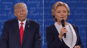 donald trump and hillary clinton are standing next to each other while talking into microphones