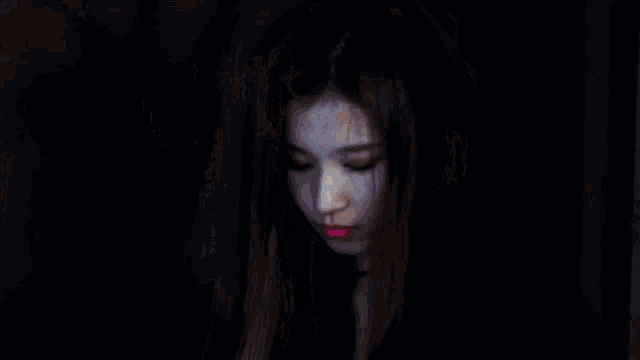 a close up of a woman 's face with a choker and pink lipstick .