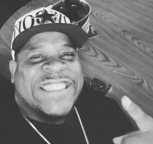 a black and white photo of a man wearing a hat that says nova on it