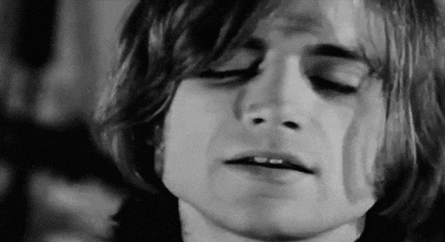 a close up of a man 's face with his eyes closed .