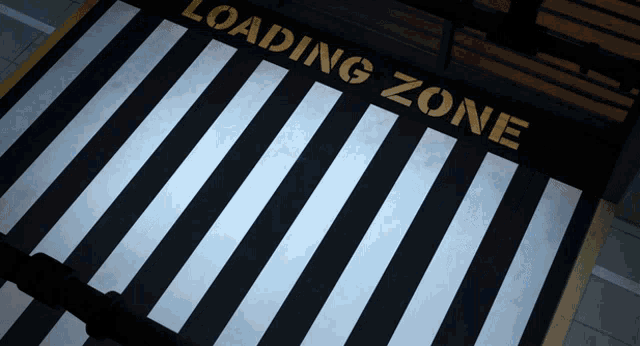 a loading zone sign with a black and white striped floor