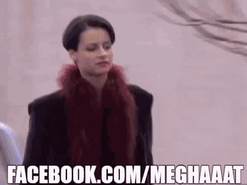 a woman wearing a black jacket and a red scarf says facebook.com/meghaaat