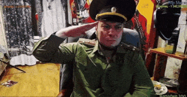 a man in a military uniform salutes while sitting in front of a computer screen that says karaoke 200