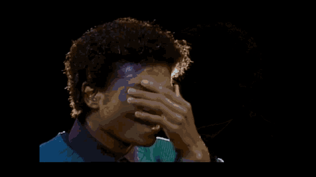 a close up of a man 's face with a shadow of a man sitting behind him .