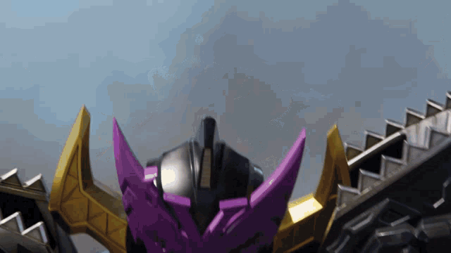 a close up of a robot with purple and gold wings