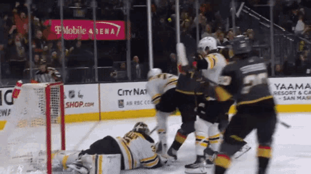 a hockey game is being played in front of a t mobile arena sign