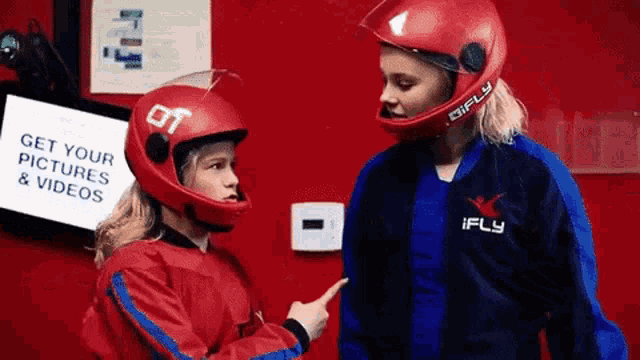 a girl wearing a red helmet that says ot on it