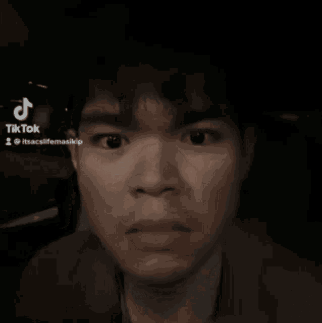 a tiktok video of a man making a funny face with his eyes wide open