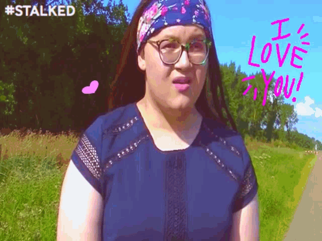 a woman wearing glasses and a headband says i love you in pink letters