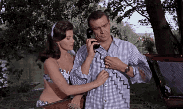 a man and a woman talking on a phone