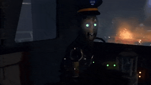 a man in a hat is sitting in a dark room