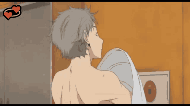 a man without a shirt is holding a towel in his arms