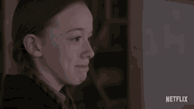 a close up of a girl 's face with the word netflix on the bottom