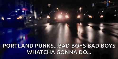 a police car is driving down a street at night