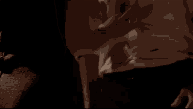 a man and a woman holding hands in a dark room .