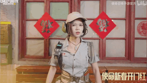 a woman in a military uniform stands in front of a call of duty advertisement