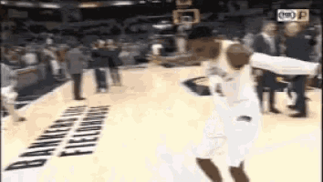 a basketball player is jumping in the air while holding a basketball in front of a banner that says bankers hill fieldhouse