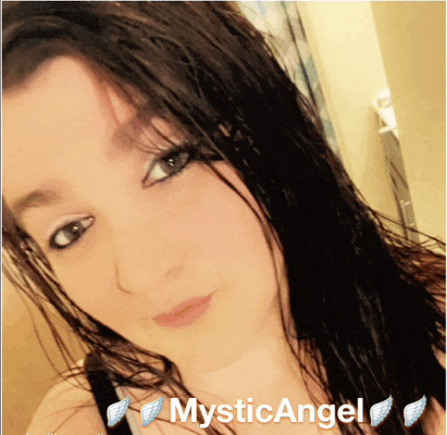 a close up of a woman 's face with mystic angel written on the bottom right