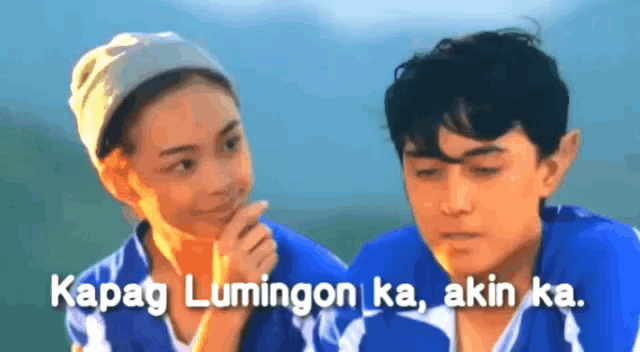 a boy and a girl are standing next to each other with the words " kapag lumingon ka akin ka " on the bottom