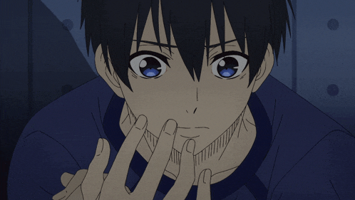 a close up of a person 's face with a blue shirt on