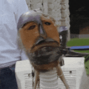 a statue of a man with a beard and a mask on