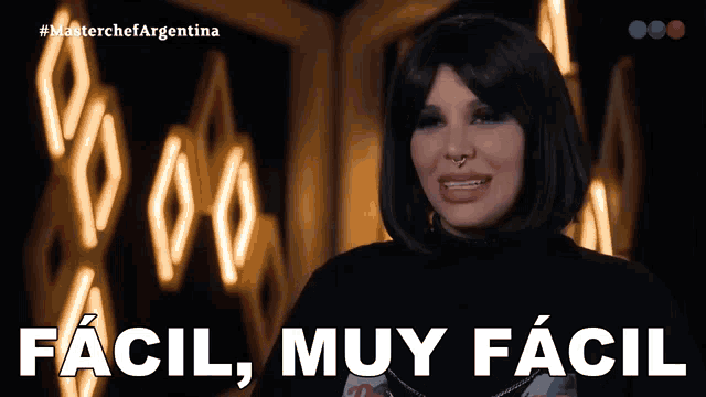 a woman says " facil muy facil " in front of a sign