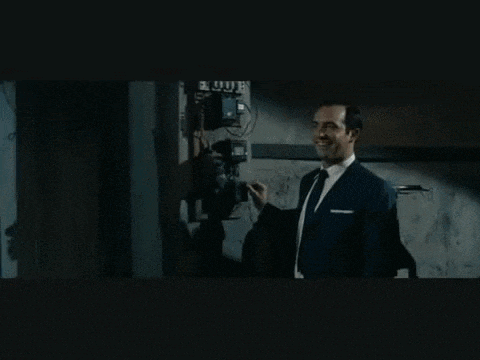 a man in a suit and tie talking on a phone
