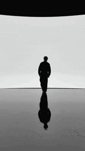 a silhouette of a man standing in front of a white background