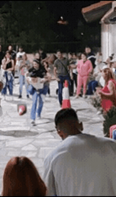 a group of people are playing a game with a soccer ball
