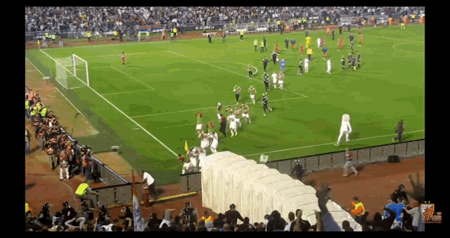 a soccer game is being played in a stadium with a large crowd