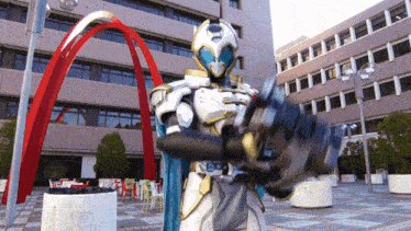 a man in a white and gold costume stands in front of a building