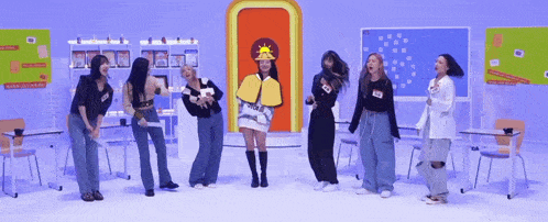 a group of women are dancing in a classroom with a woman wearing a hat that says sun