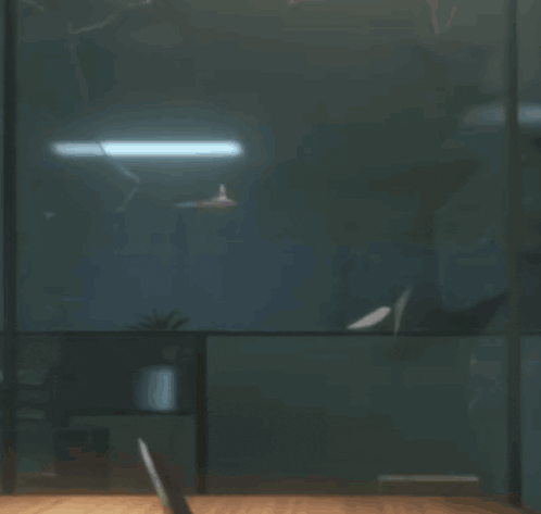 a person sitting at a desk in a dark room