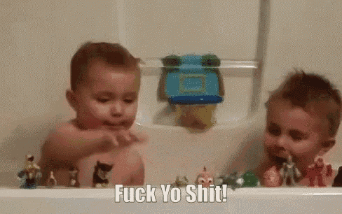 two young boys are playing in a bathtub with toys and the words `` fuck yo shit '' written on the bottom .
