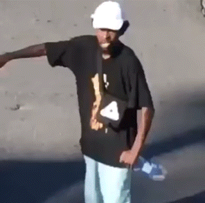 a man wearing a white hat and a black shirt with a triangle on it
