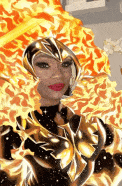 a woman in a golden armor with flames around her