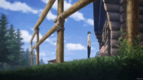 a man and a woman are standing in front of a wooden building .