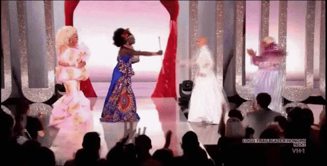 a group of drag queens are dancing on a stage in front of a crowd with the words vh1 on the bottom