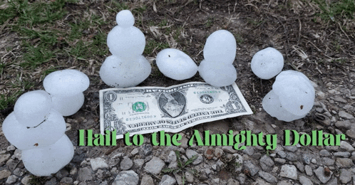 a dollar bill is laying on the ground next to hail