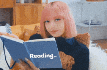 a girl with pink hair is reading a blue book