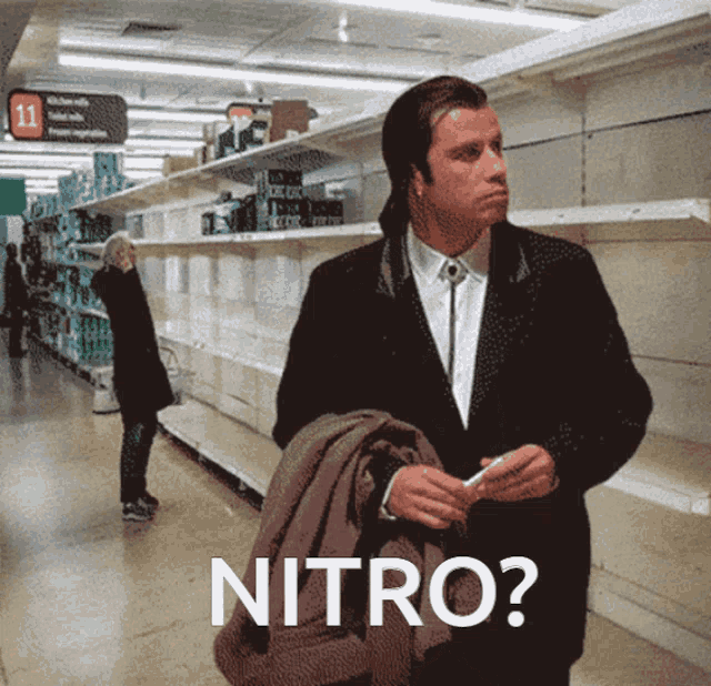 a man in a suit is standing in front of empty shelves with the words nitro written on the bottom
