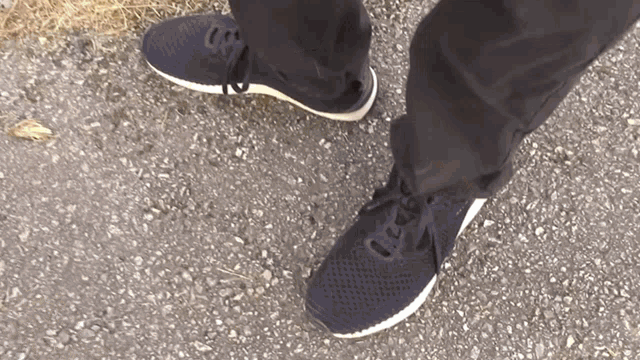 a person wearing a pair of black and white shoes