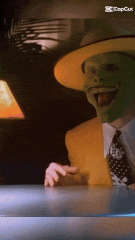 a man wearing a green mask and a yellow hat is pointing